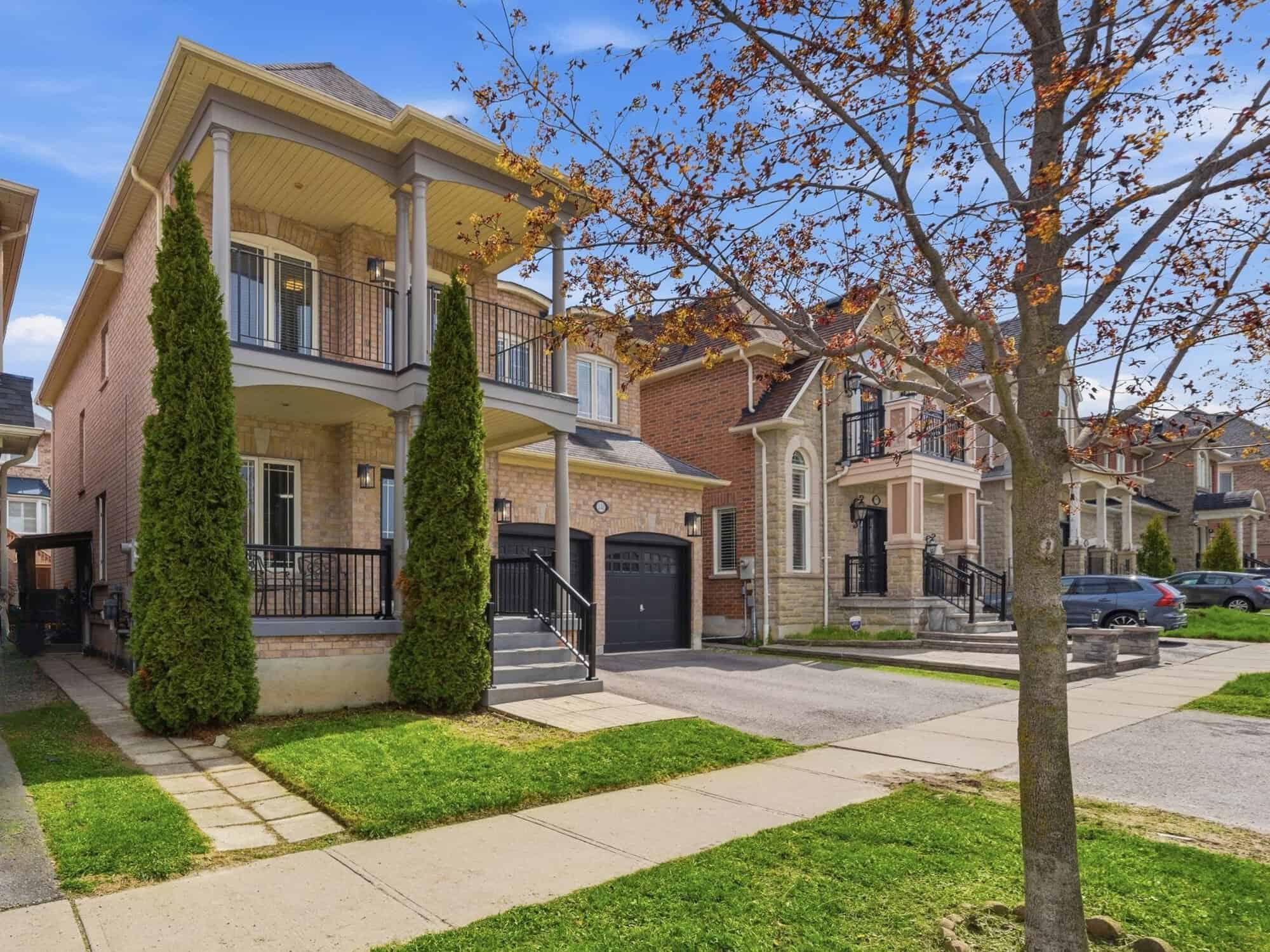 Street-level exterior of 131 Rushworth Drive, Ajax, a brick two-storey detached home with a covered porch, listed by Laura McBride, Ajax REALTOR®