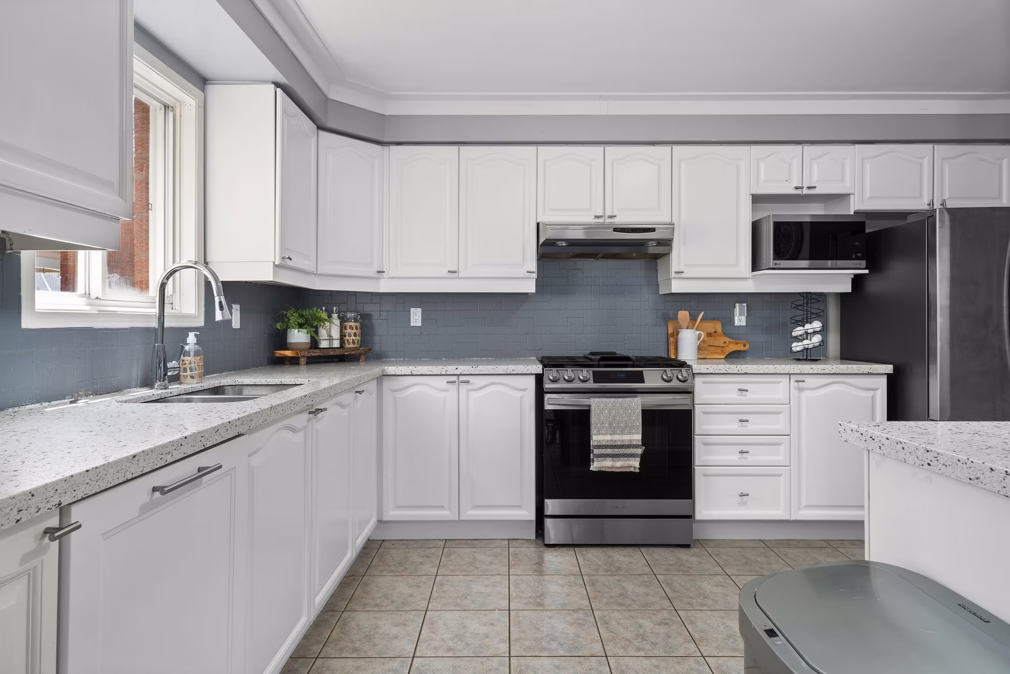 Kitchen at 1509 Grandview Street North, Oshawa, with a gas stove and white cabinetry