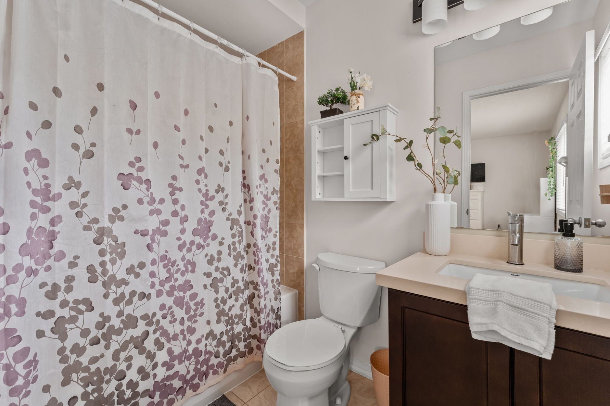 Second bedroom ensuite at 1683 Finkle Drive, Oshawa, with a floral shower curtain and dark wood vanity