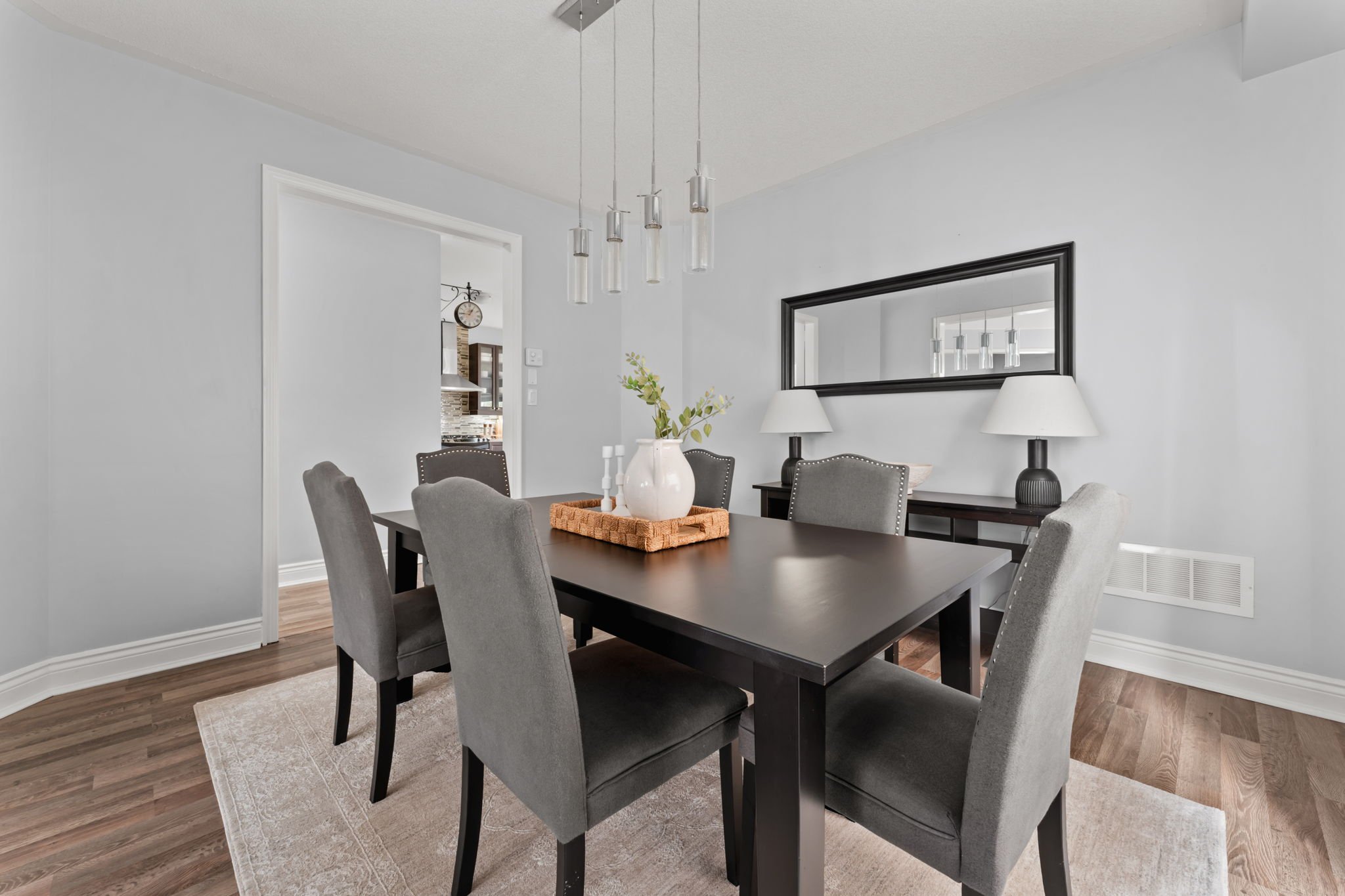 Formal dining room at 1683 Finkle Drive, Oshawa, with seating for six beneath a modern pendant light fixture