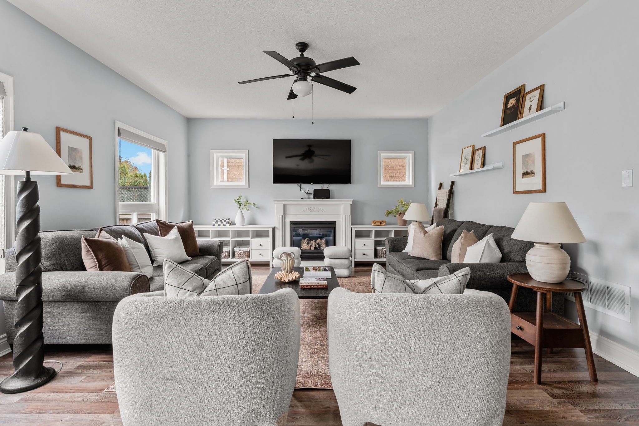Open-concept family room at 1683 Finkle Drive, Oshawa, with a gas fireplace and symmetrical seating