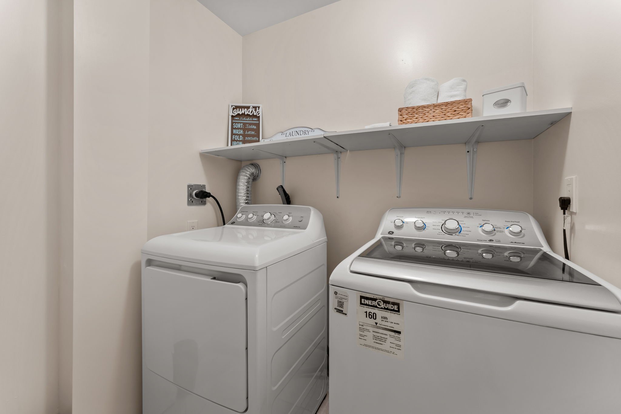 Upper-level laundry room at 1683 Finkle Drive, Oshawa, with built-in shelving
