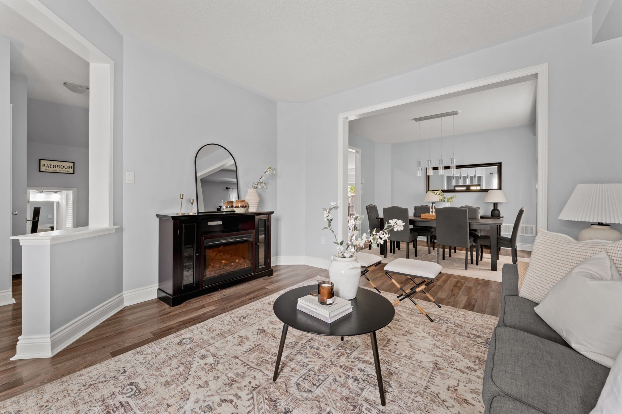 Formal living room at 1683 Finkle Drive, Oshawa, with hardwood floors, a media console and sightlines to the dining room