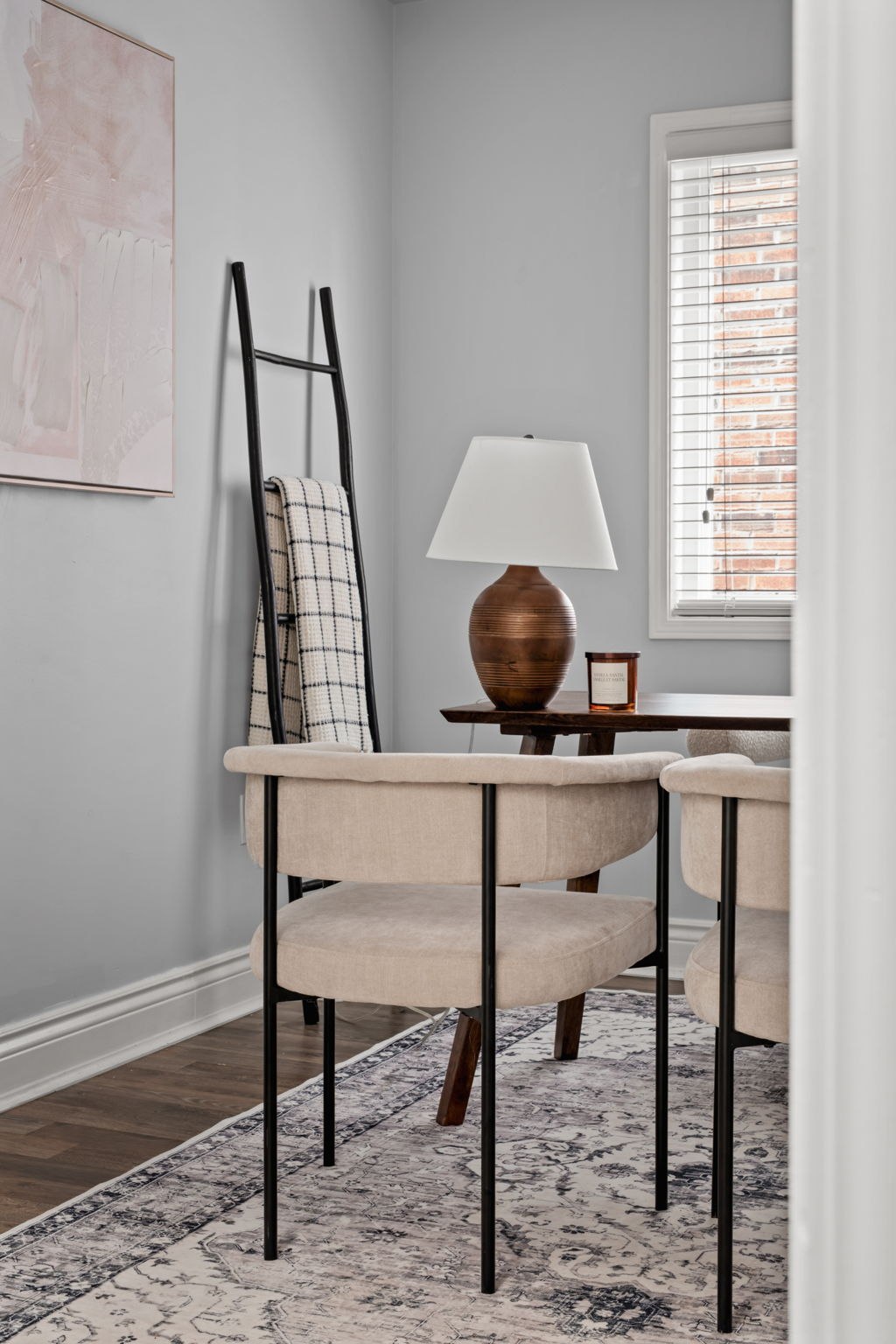 Office styling detail at 1683 Finkle Drive, Oshawa, with a blanket ladder, ceramic lamp and accent chairs
