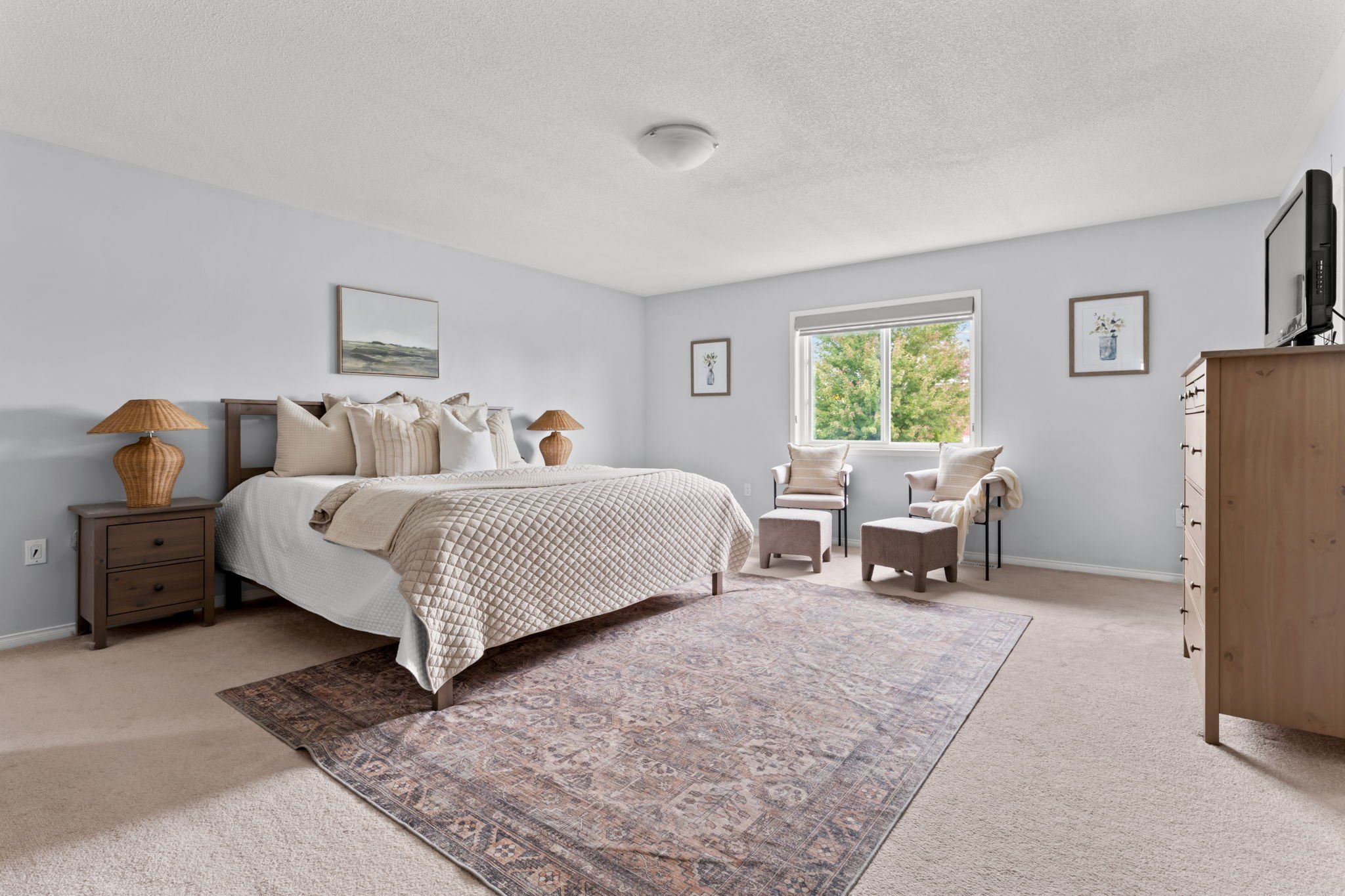 Primary bedroom at 1683 Finkle Drive, Oshawa, with a sitting area, his and hers closets and large windows