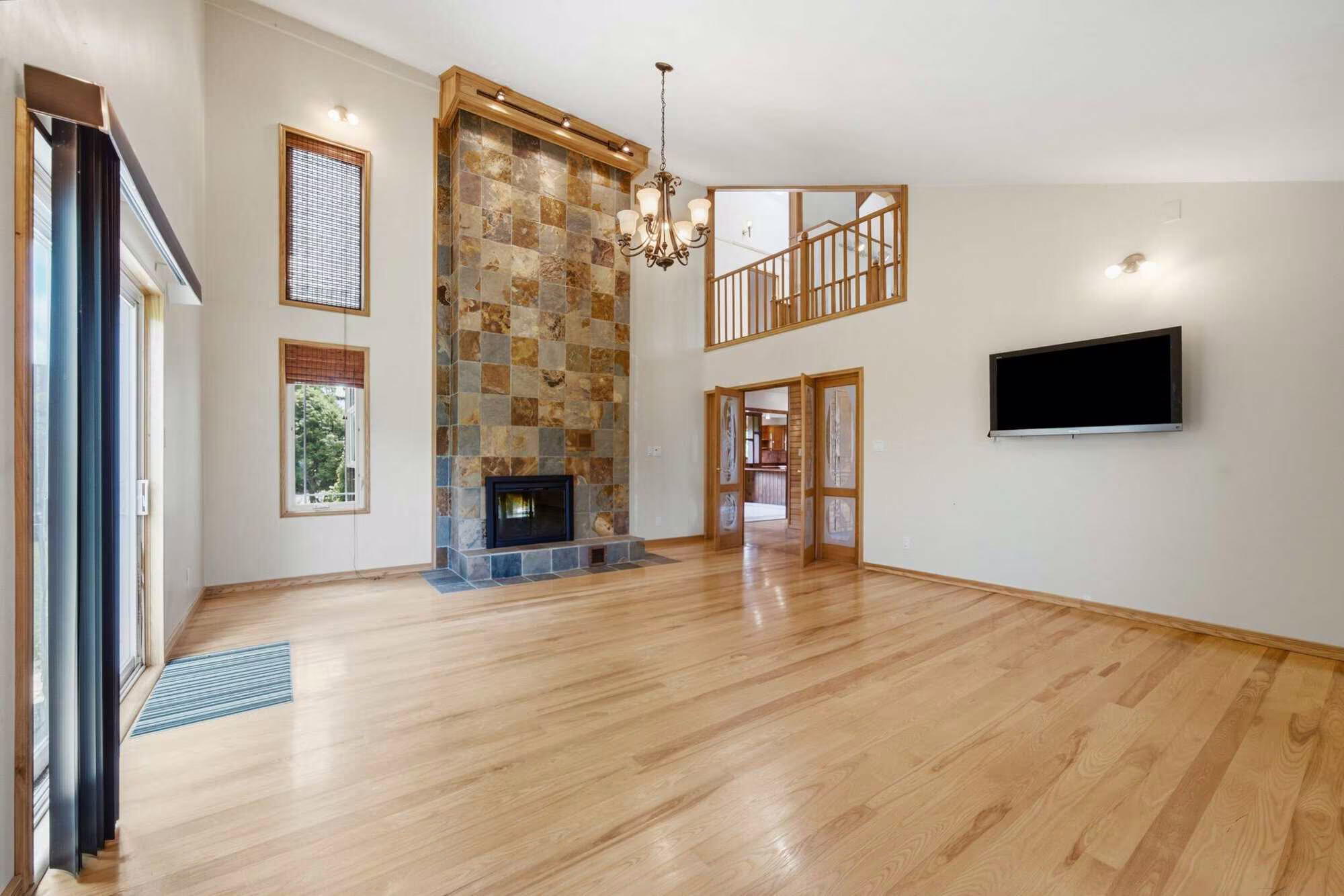 Great room at 17 Ontoro Blvd, South East Ajax, with a floor-to-ceiling stone fireplace and vaulted ceilings