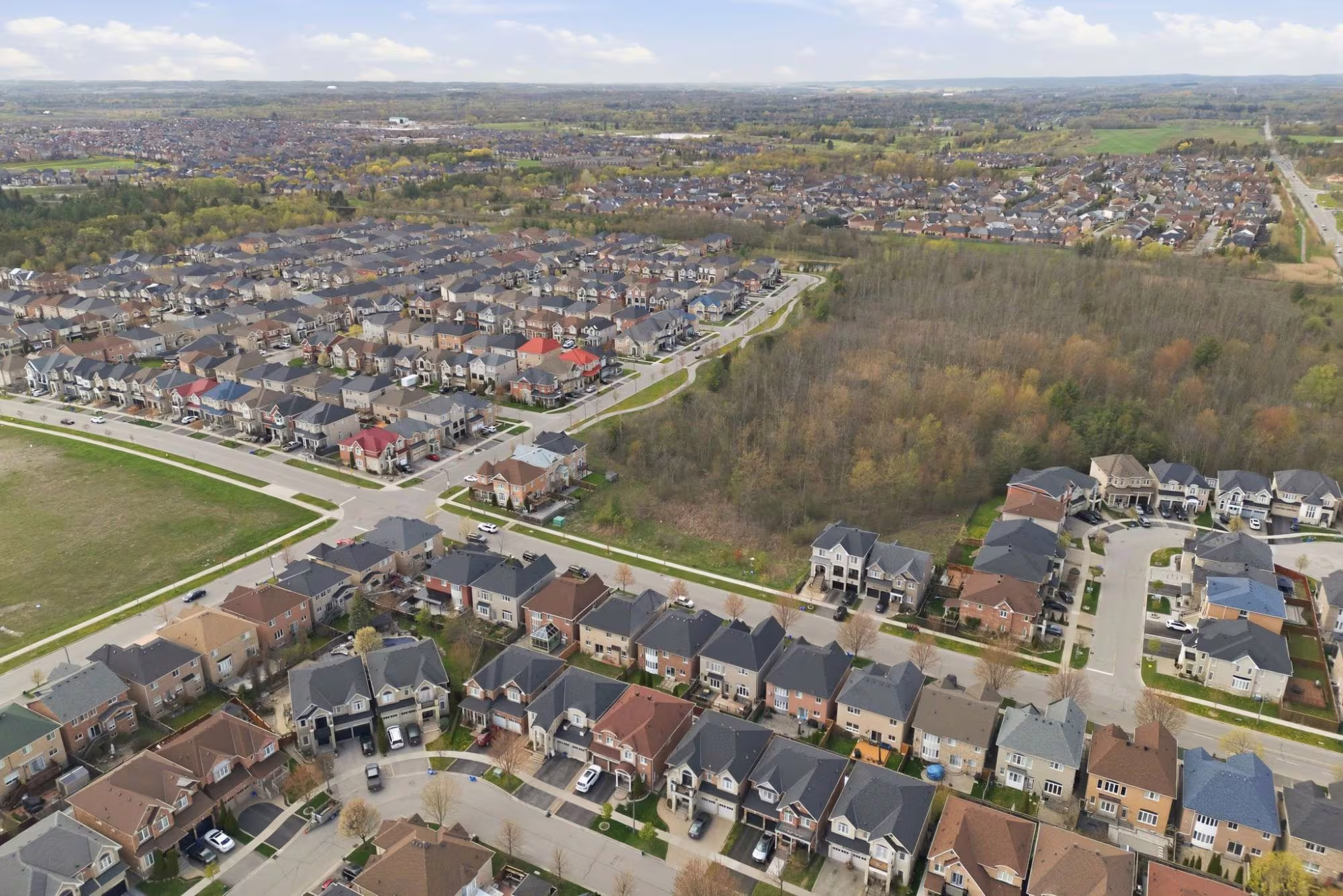 Aerial view of a newer Northeast Ajax subdivision bordering greenspace