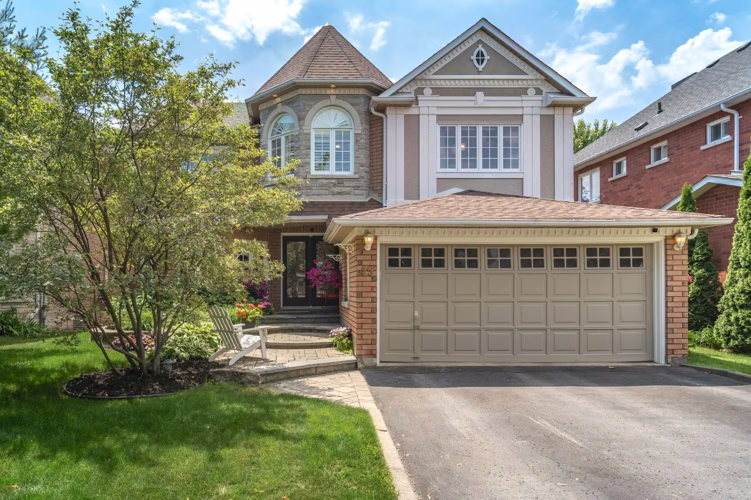 A detached two-storey home with a turret feature and double garage in Riverside, Ajax