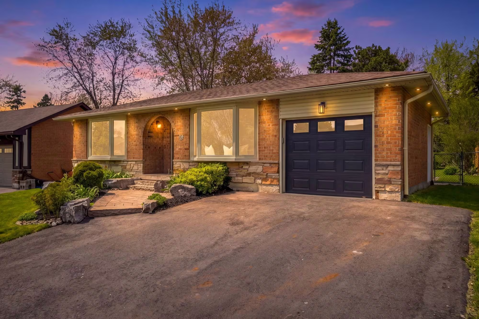 A renovated brick bungalow at twilight in South Ajax, Duffin's Bay