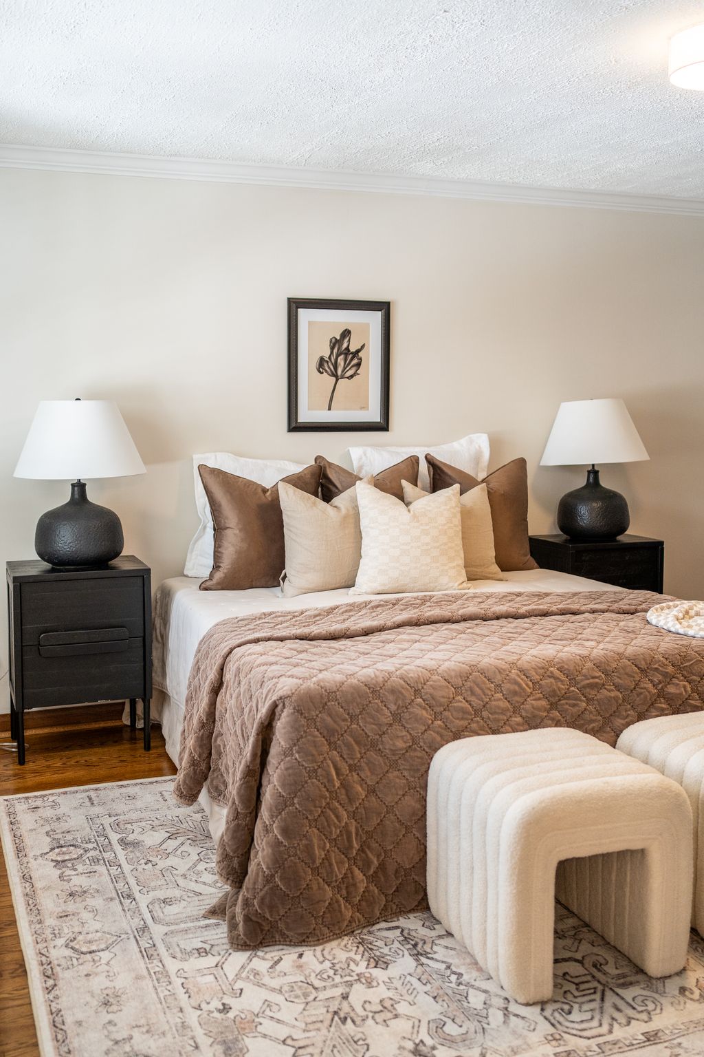 a bed with pillows and a lamp on top of it