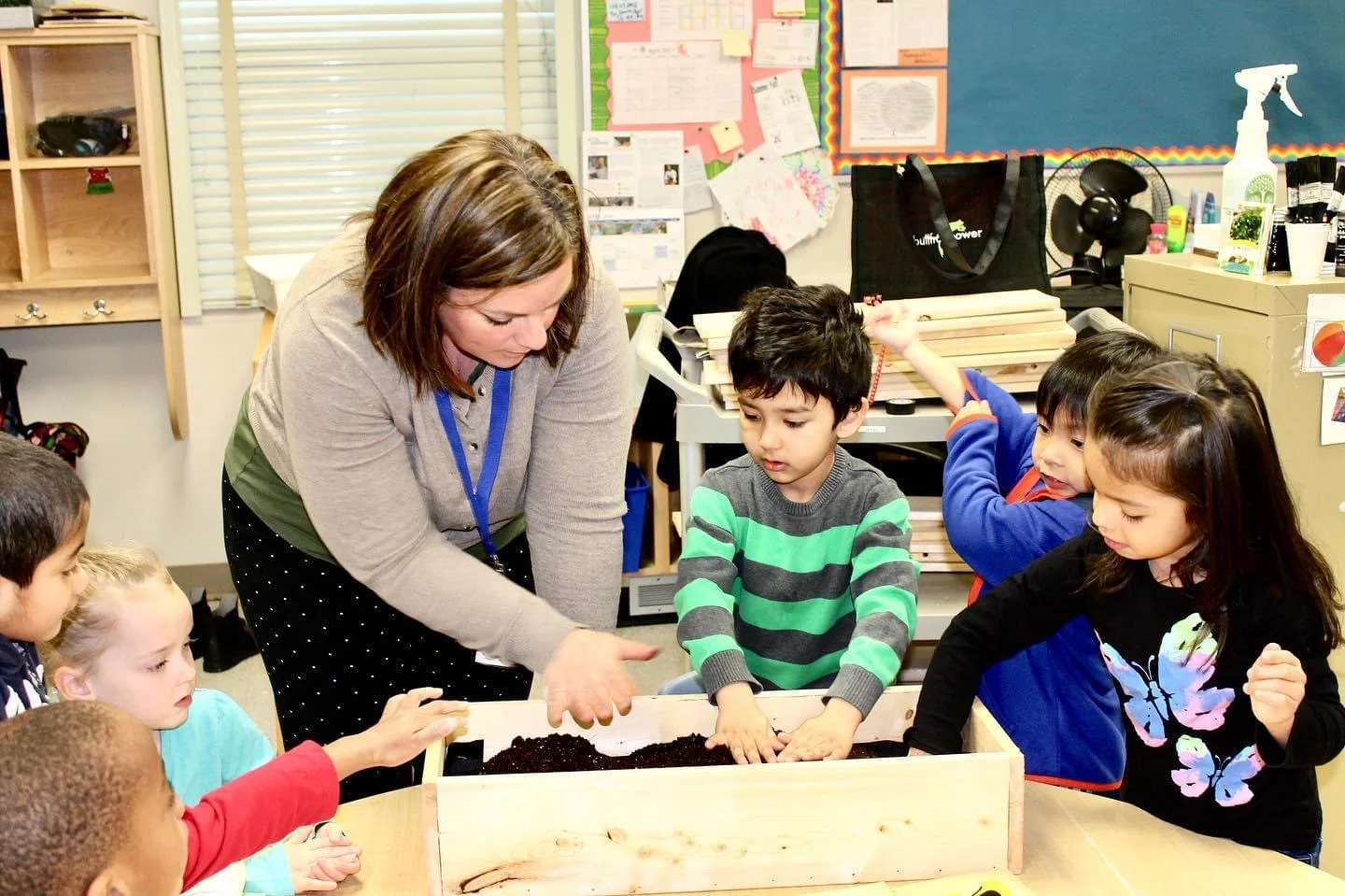 Laura McBride guiding a kindergarten class through a hands-on planting activity part of Junior Green Thumbs