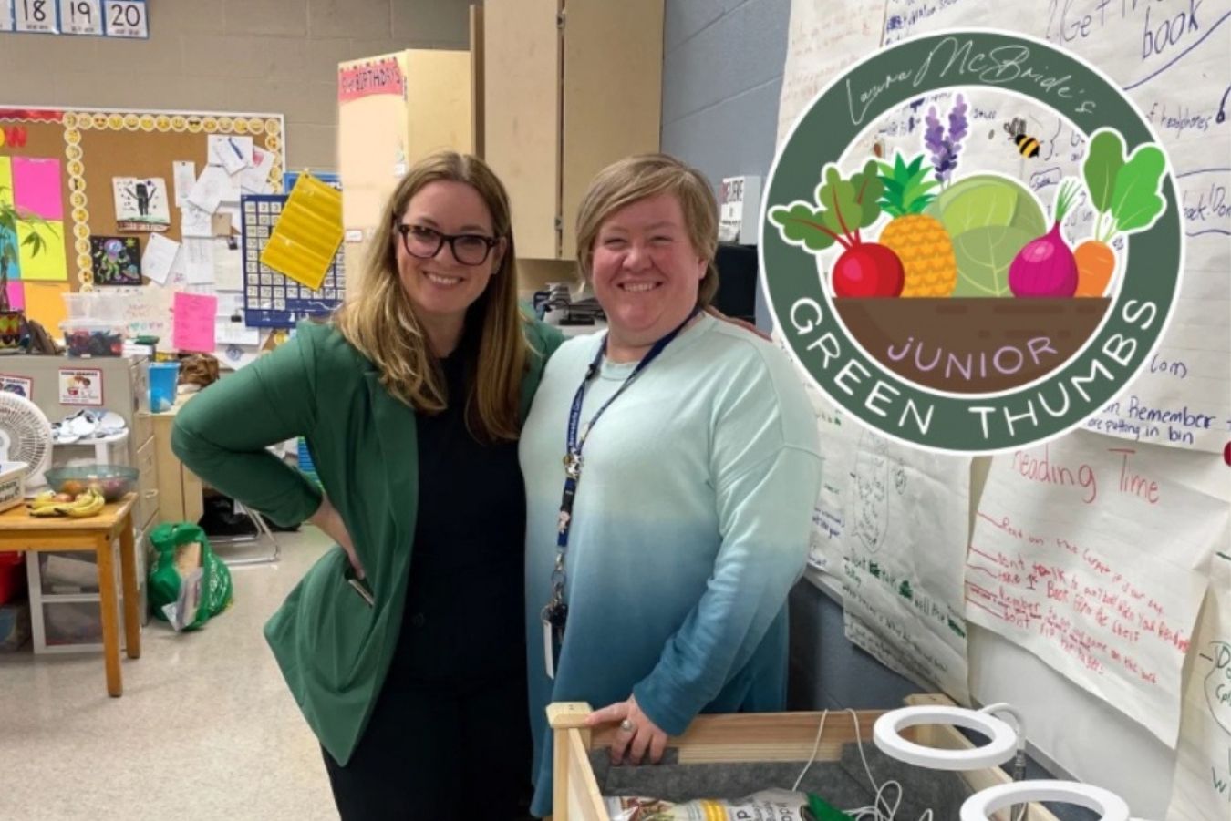 Laura stands with a teacher who received a Junior Green Thumbs Garden in her classroom.