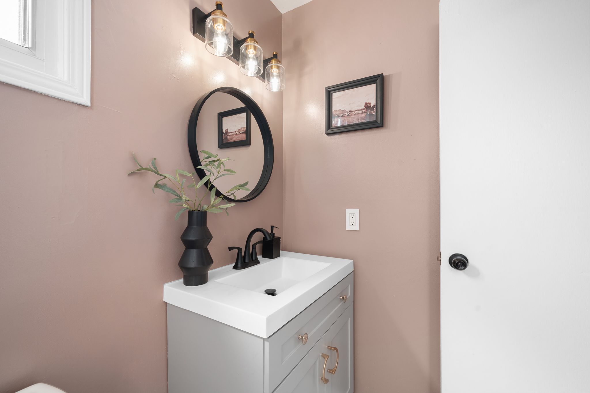 Renovated upper bathroom with wood vanity, matte black hardware, and white tile finishes