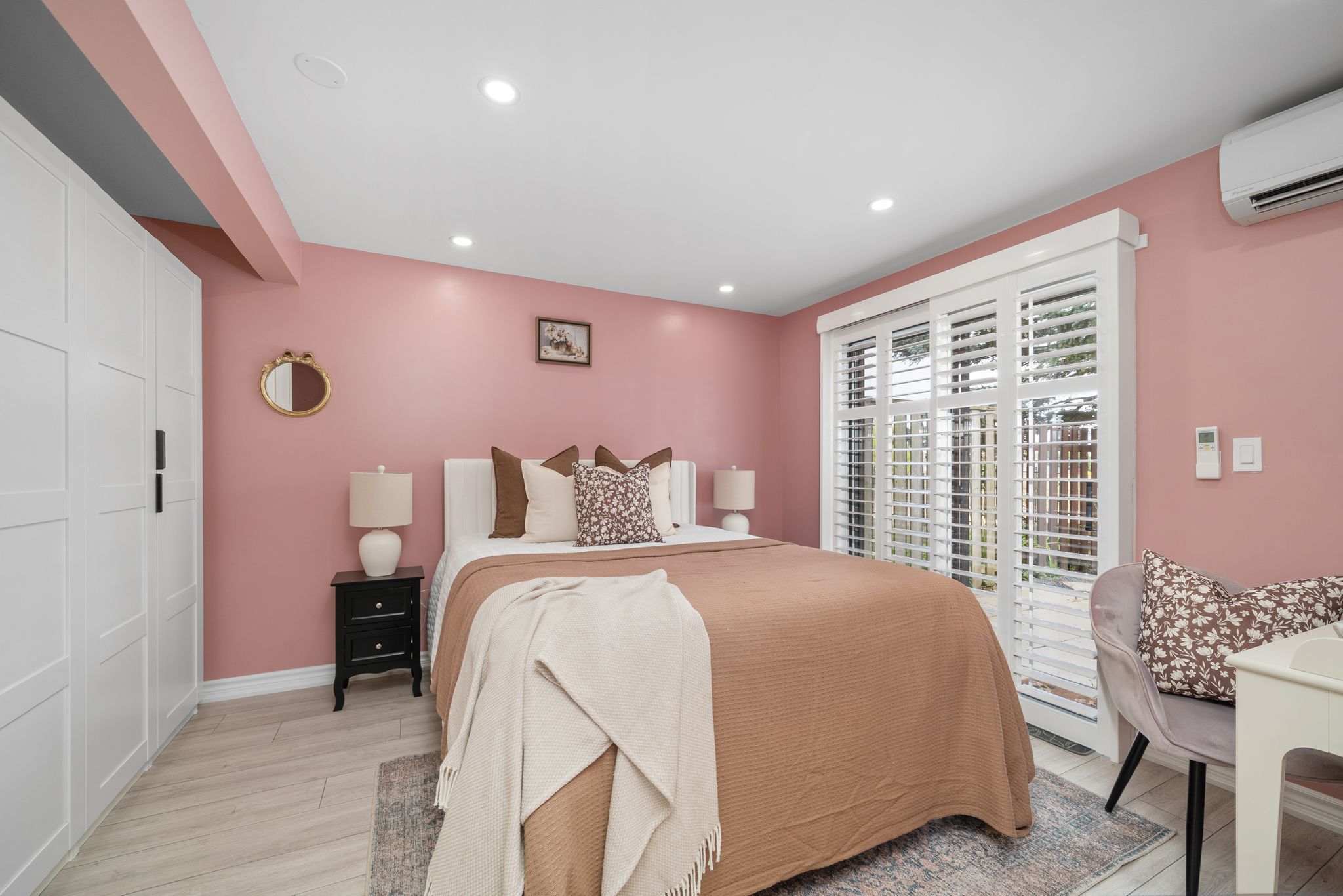 Lower-level bedroom with natural wood accents and neutral bedding
