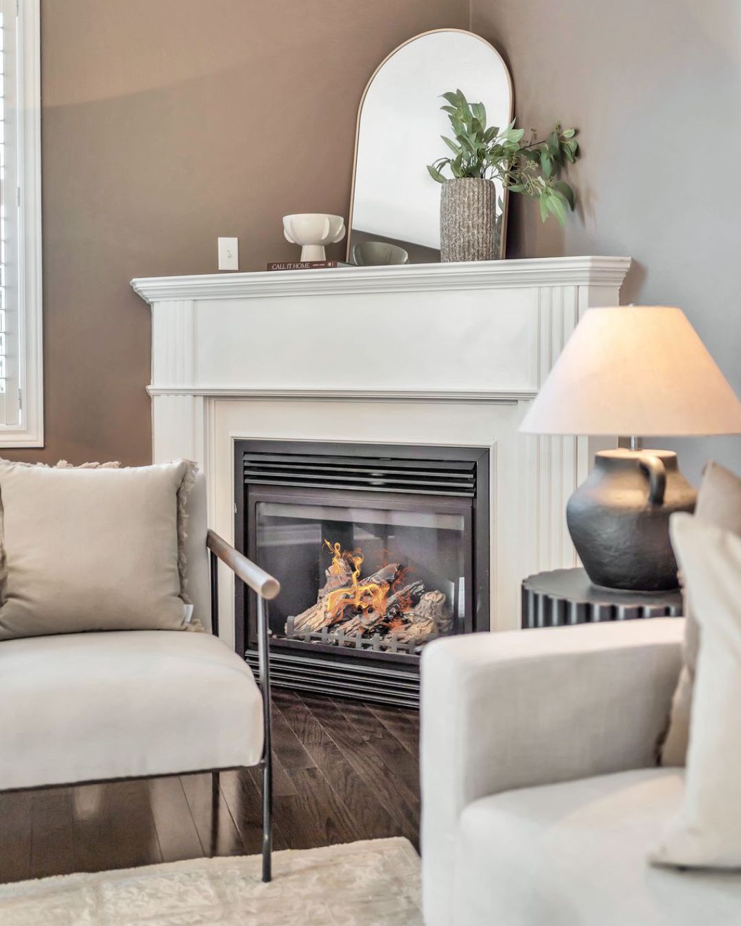 Living room fireplace at 14 Sleepy Hollow Place in Whitby, framed by a white mantel with decor accents and surrounded by cozy seating.