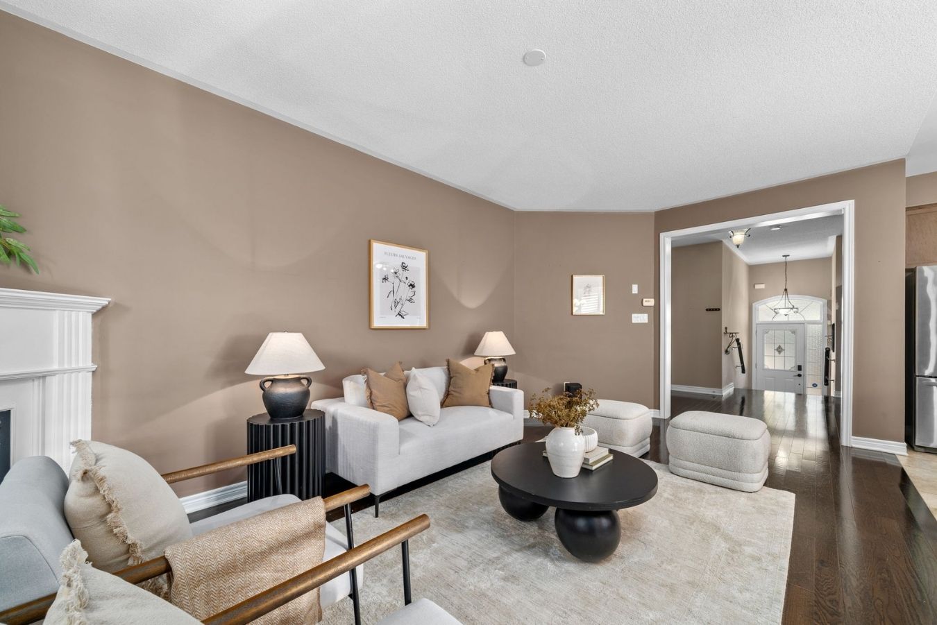 Living room at 14 Sleepy Hollow Place in Whitby with neutral furnishings, coffee table, accent lighting, and view toward the front entry.