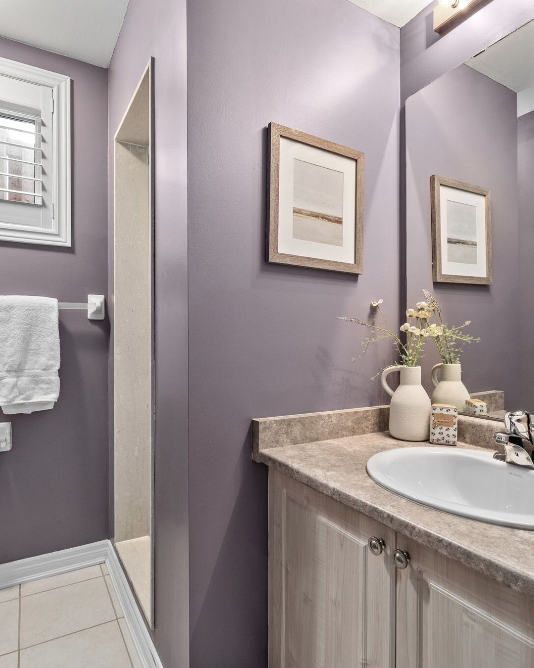Basement bathroom at 14 Sleepy Hollow Place with shower, framed mirror, and single-sink vanity.