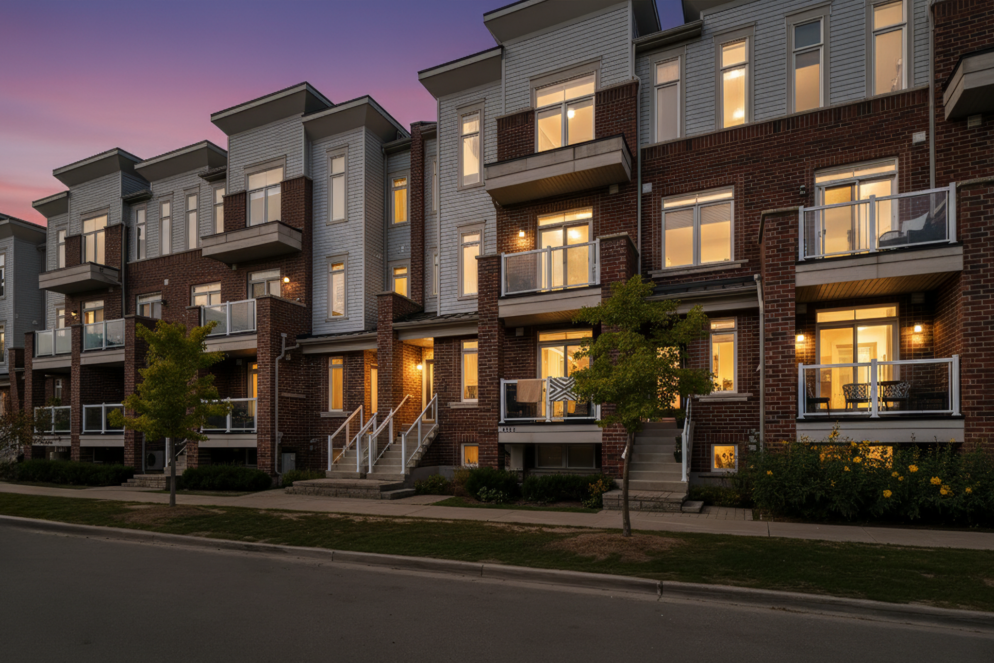 Front exterior of stacked townhouse at 2598 William Jackson Dr Pickering with brick and siding design, steps, and balconies.