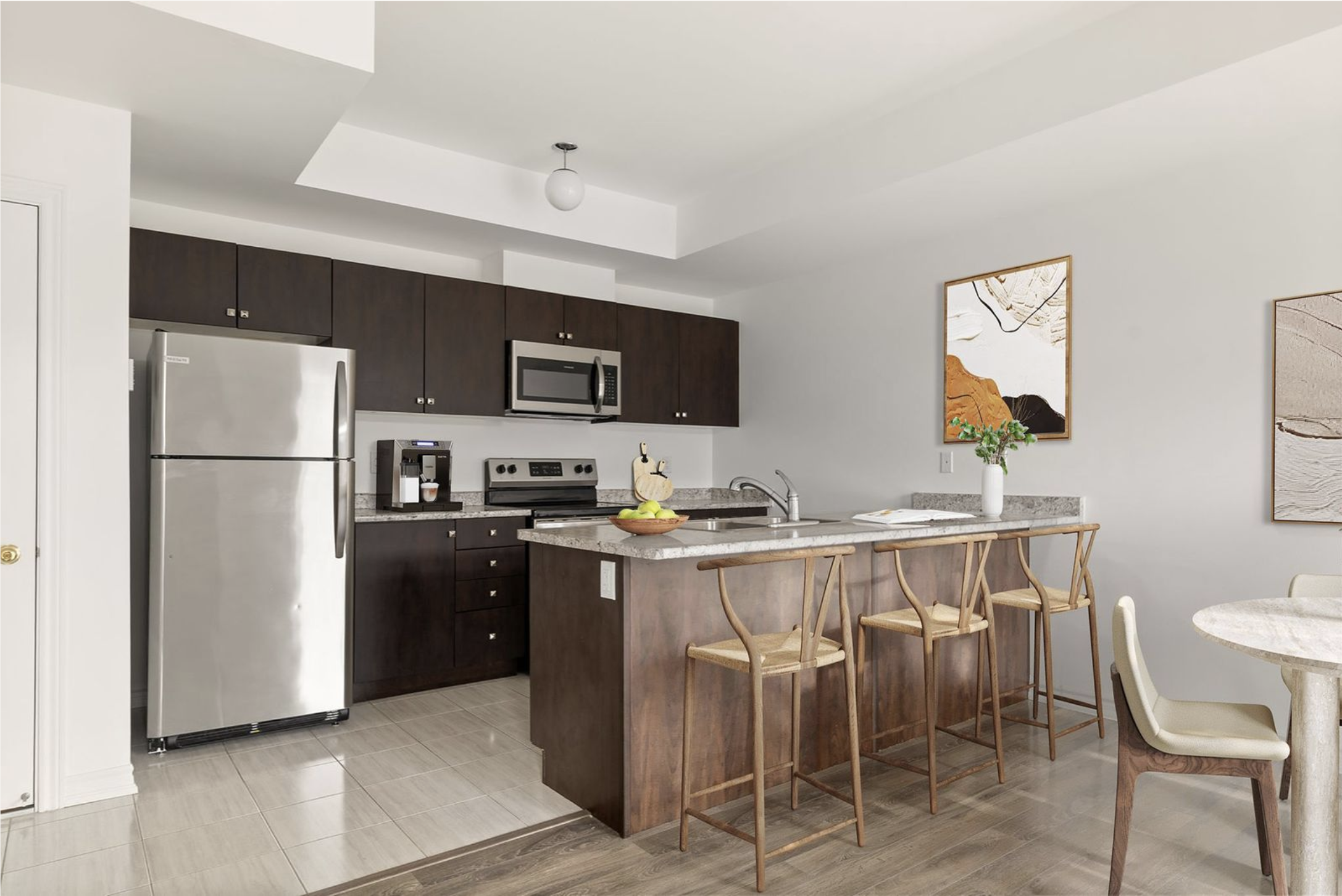 Kitchen with stainless steel appliances and dark cabinetry at 2598 William Jackson Dr Pickering.
