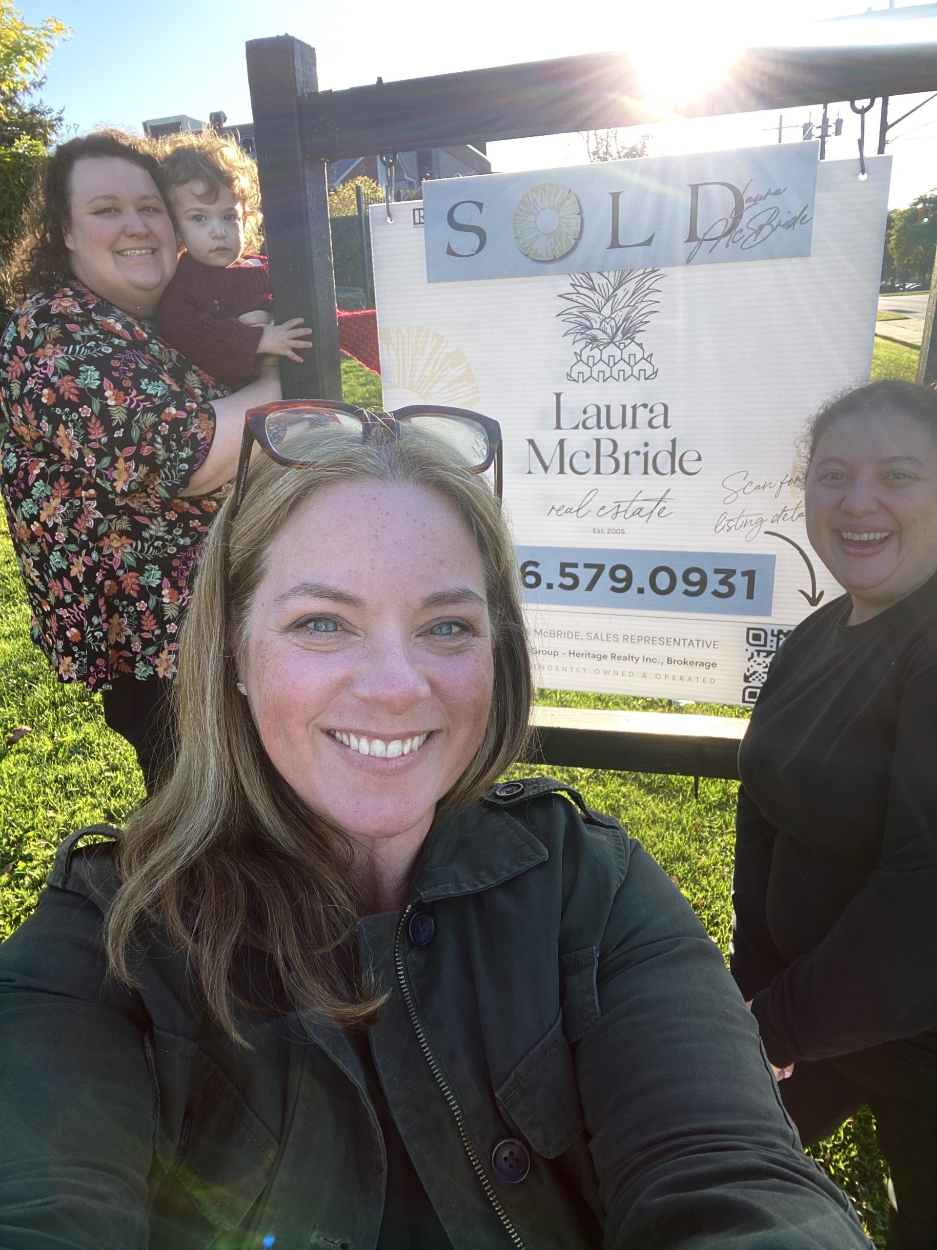 Laura-with-Co-Buyers Realtor Laura McBride smiling with her happy co-buyer clients in Pickering after successfully selling their home before moving to their new one.