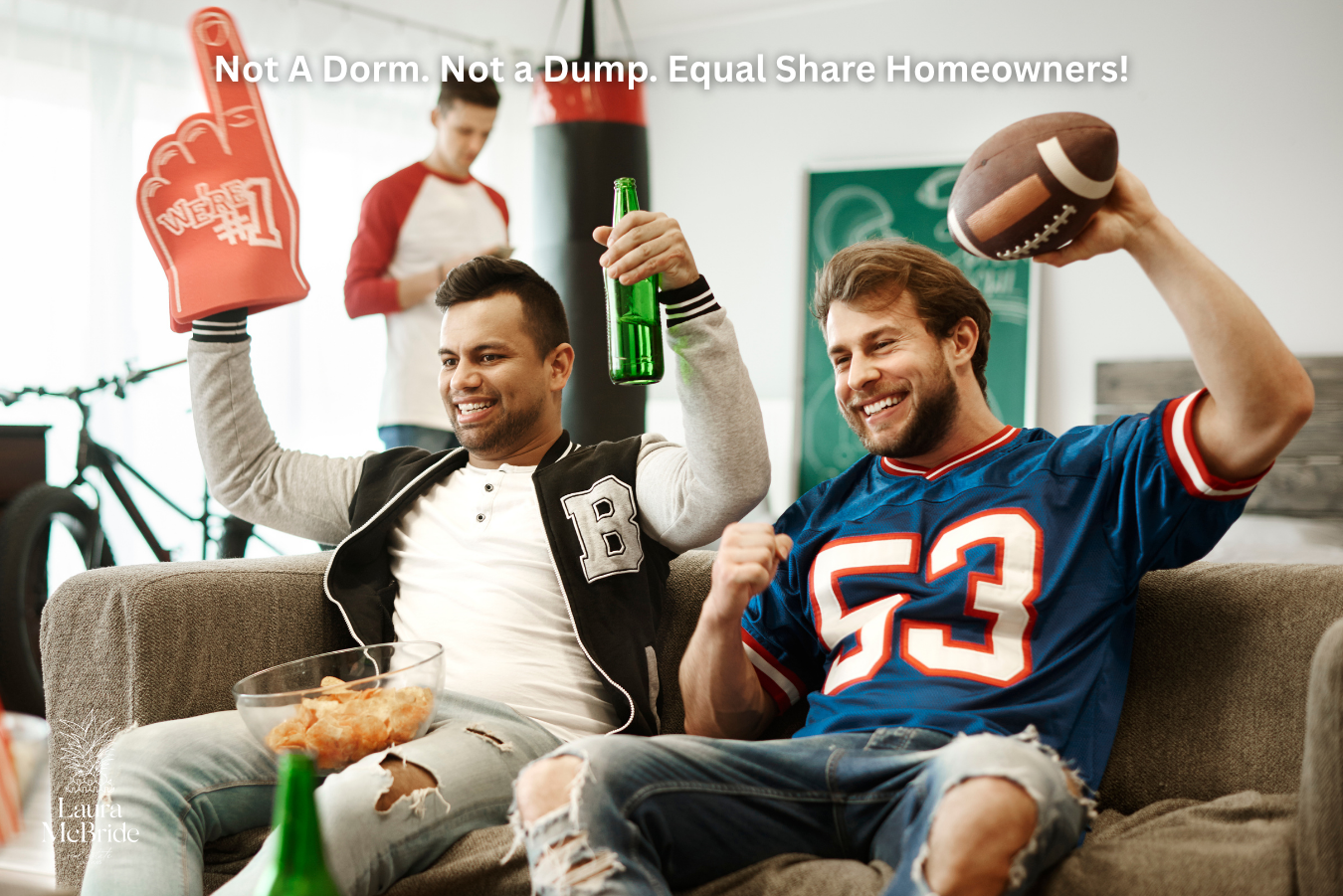 Two friends cheering on a game in their shared home after co-buying property together in the Greater Toronto Area.