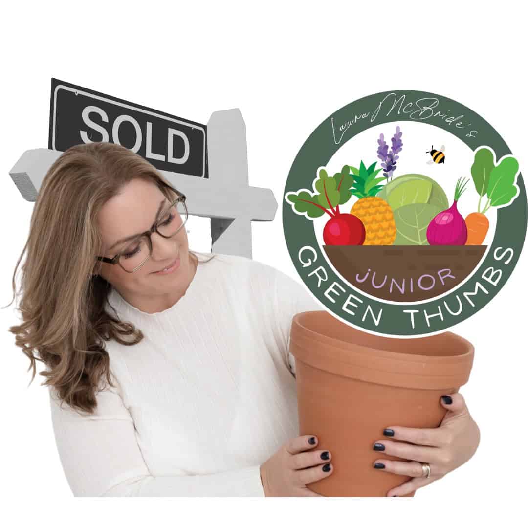 Laura McBride holding a large terracotta pot beside the Junior Green Thumbs classroom garden logo with a sold sign in the background.