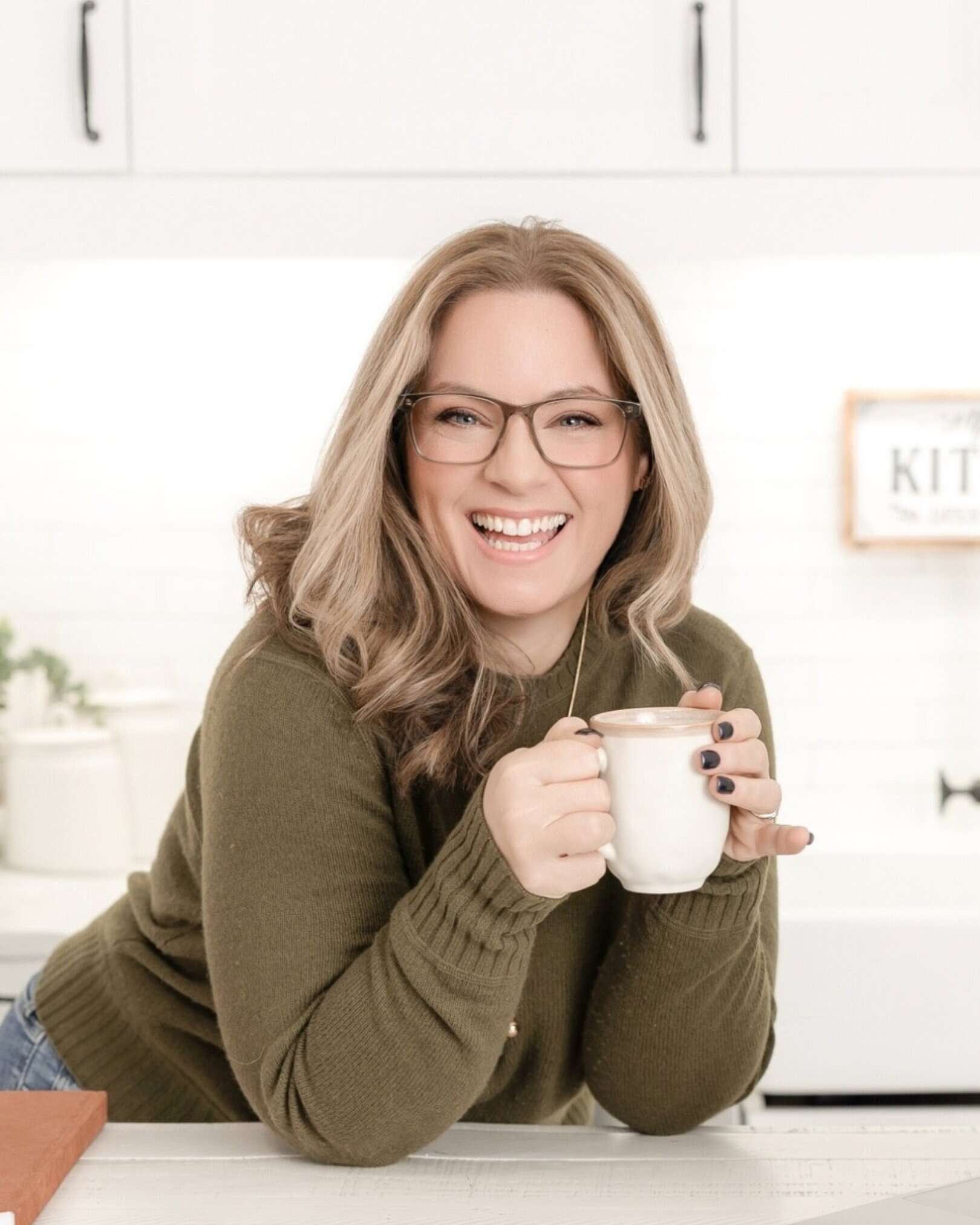 Laura McBride, trusted Ajax Realtor supporting local moves and Ontario relocations, smiling with a coffee in a bright home environment.