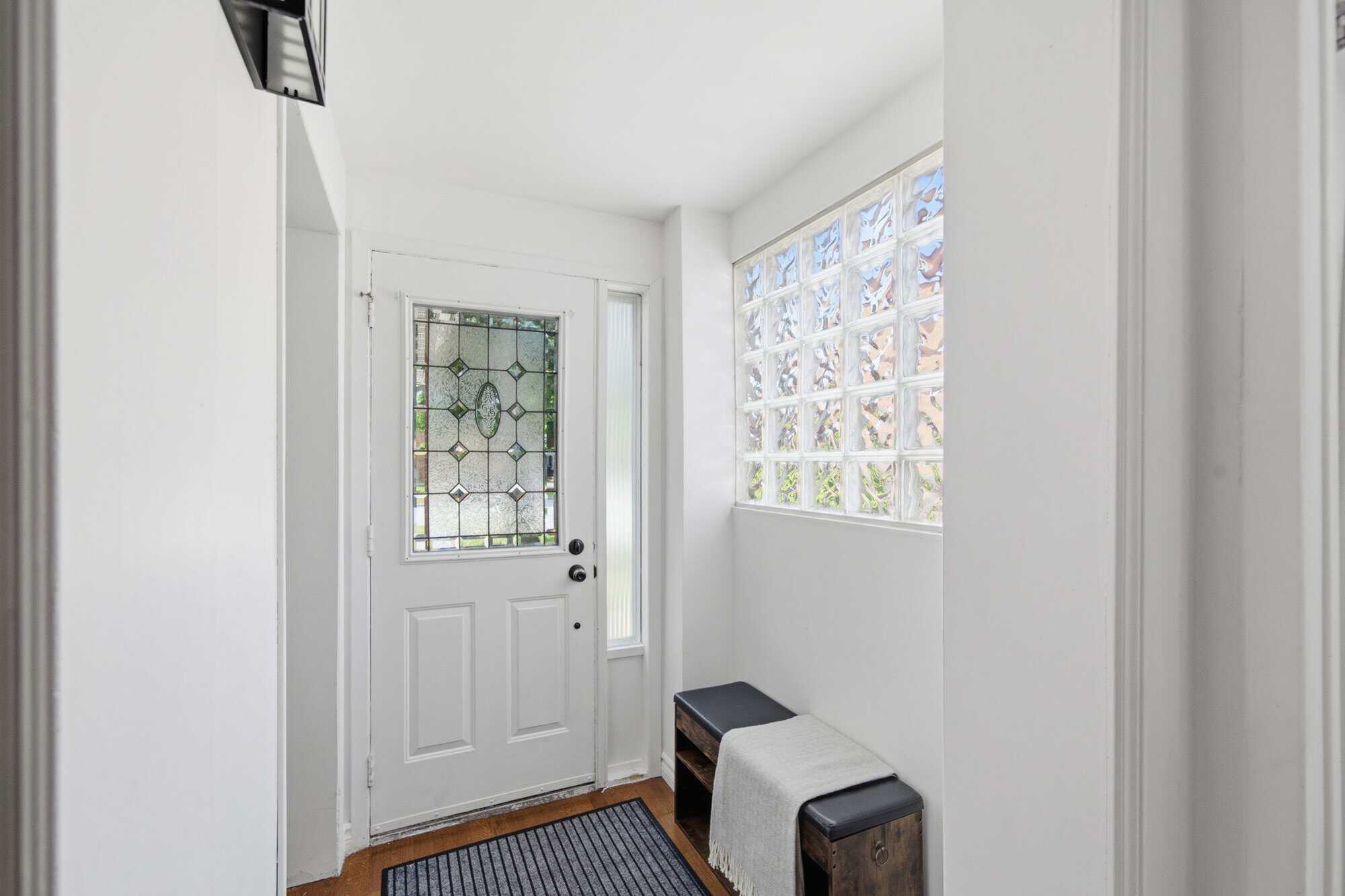 Interior hallway at 39 Anstead Crescent in Ajax with hardwood floors, pot lights, and kitchen access.