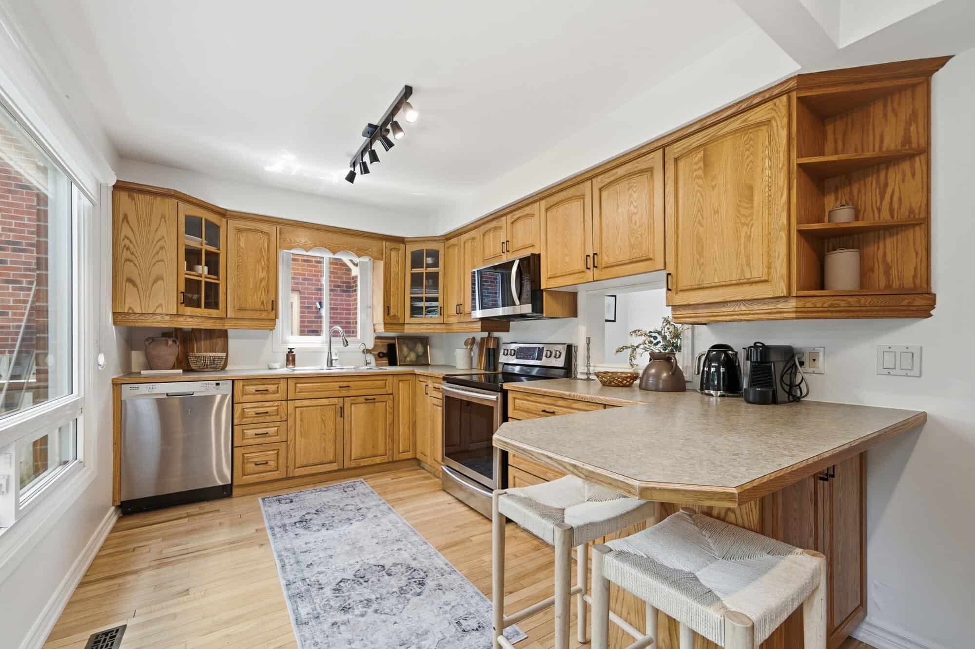 Kitchen at 13 Flowers Crescent in Ajax with oak cabinets, stainless steel appliances, breakfast bar and hardwood floors.