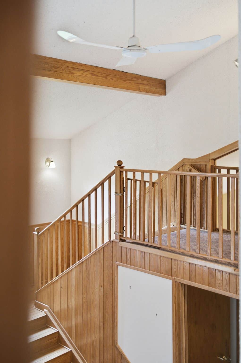 Open upper hallway overlooking the foyer with vaulted ceilings, exposed beam, and hardwood staircase at 17 Ontoro Blvd Ajax listed by top Realtor Laura McBride