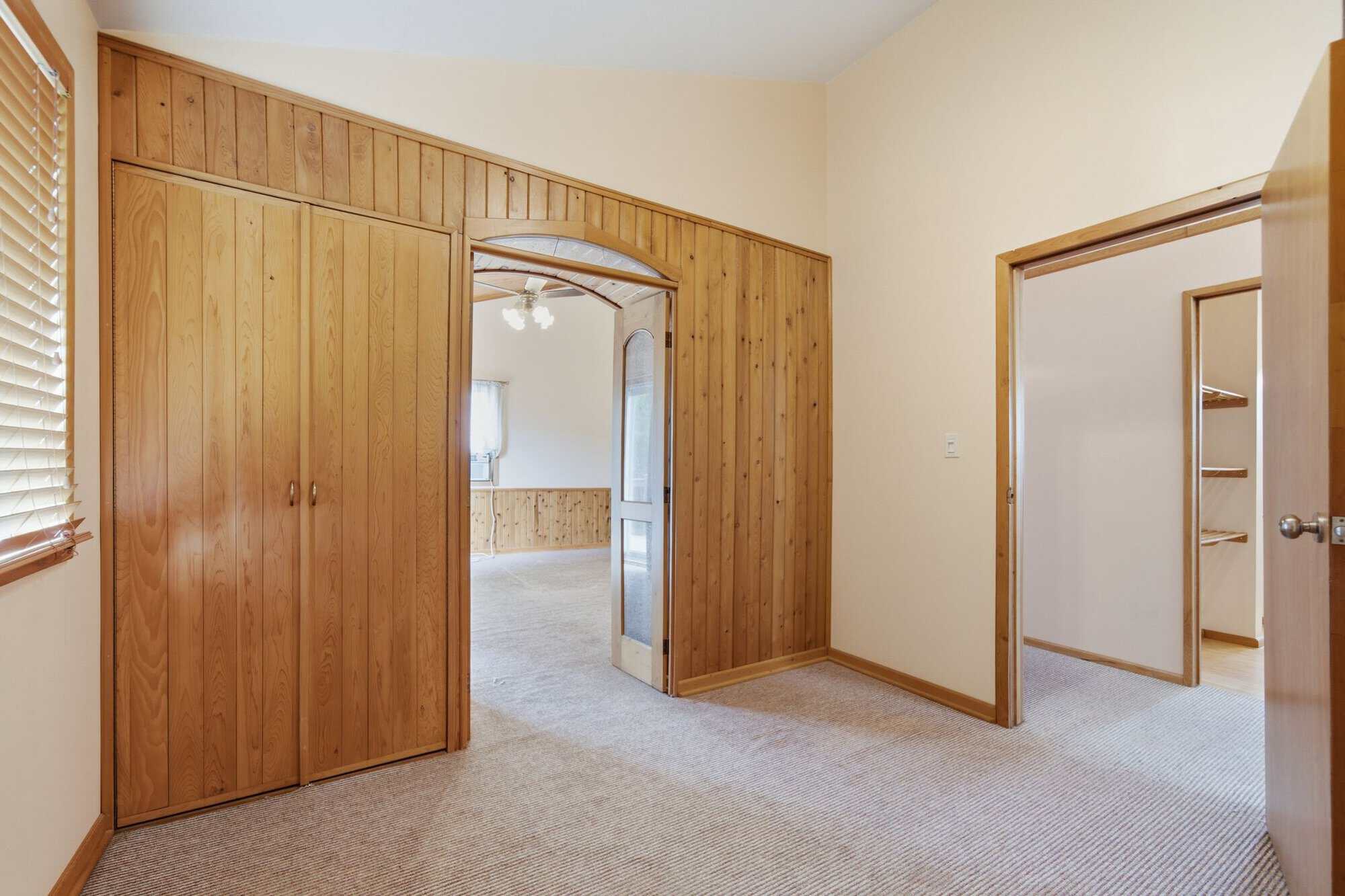 Private dressing room or den with built-in closet, adjoining walk-in closet, and access to the primary bedroom. Could also be a fourth bedroom