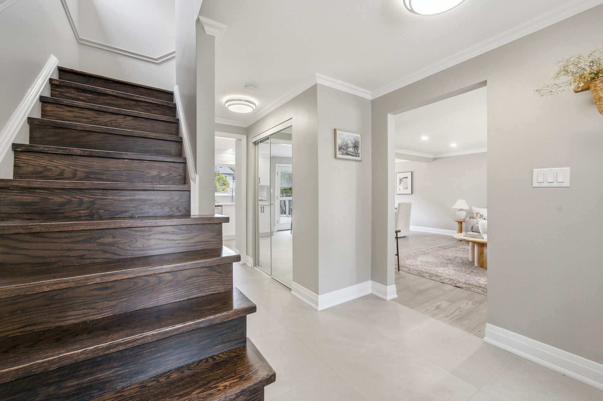 Front entry at 39 Anstead Crescent in Ajax with tile flooring, glass-panel door, and living room access.