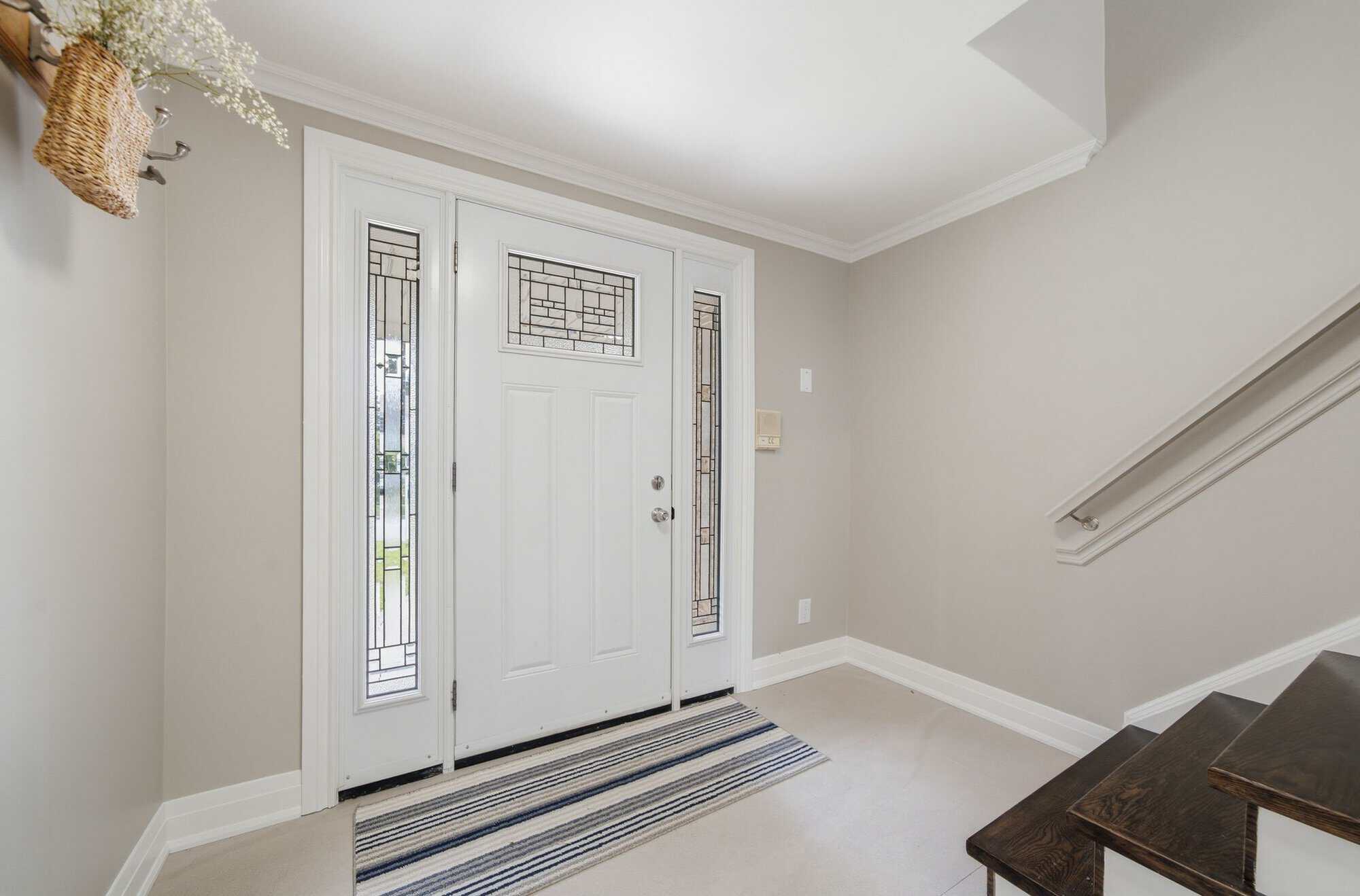 Interior hallway at 39 Anstead Crescent in Ajax with hardwood floors, pot lights, and kitchen access.