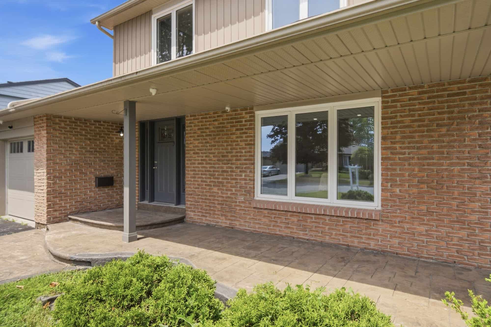 Front view of 39 Anstead Crescent, a brick detached Ajax bungalow for sale with landscaped gardens and a garage.